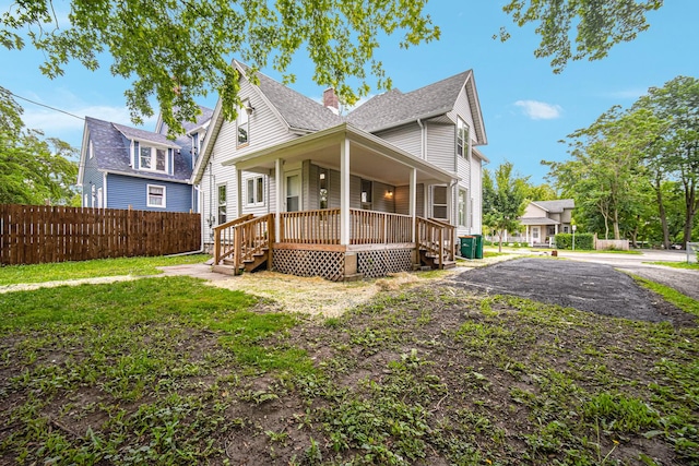 207 Iowa Ave, Joliet, IL 60433 - view of front of house with a porch, roof with shingles, and a chimney