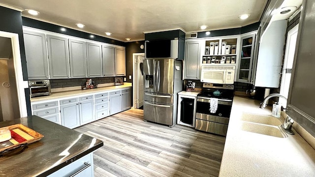 644 Genesee Ave, Morrison, IL 61270 - kitchen with appliances with stainless steel finishes, decorative backsplash, light wood-style floors, and recessed lighting