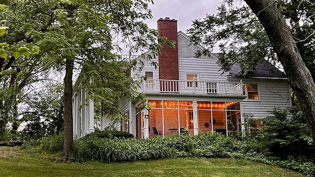 644 Genesee Ave, Morrison, IL 61270 - rear view of property featuring a balcony, a chimney, and a yard