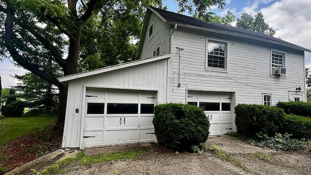 644 Genesee Ave, Morrison, IL 61270 - view of side of home featuring a garage and cooling unit