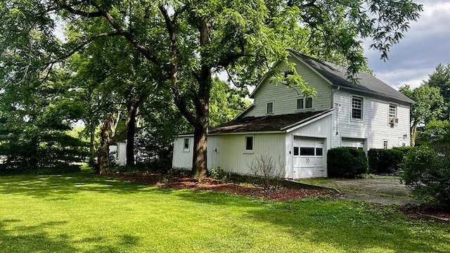 644 Genesee Ave, Morrison, IL 61270 - view of property exterior featuring driveway, a yard, a garage, and a shingled roof