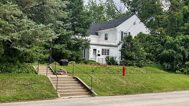 644 Genesee Ave, Morrison, IL 61270 - view of front of home featuring stairs, a balcony, and a front lawn