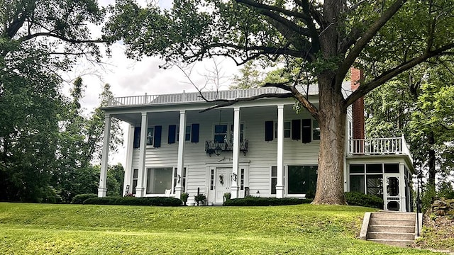 644 Genesee Ave, Morrison, IL 61270 - greek revival house with a balcony, a front lawn, and a sunroom
