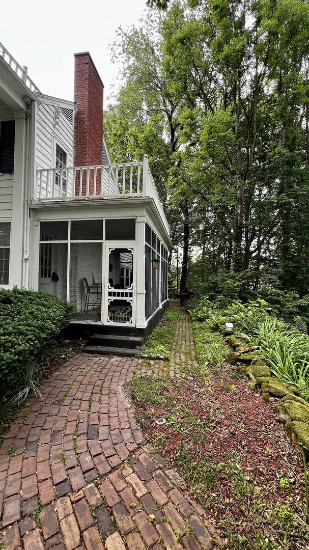 644 Genesee Ave, Morrison, IL 61270 - view of property exterior with a sunroom, a chimney, and a balcony
