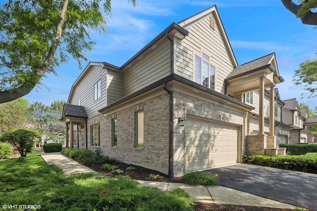 122 Santa Fe Ln, Willow Springs, IL 60480 - view of property exterior featuring a garage, brick siding, and asphalt driveway