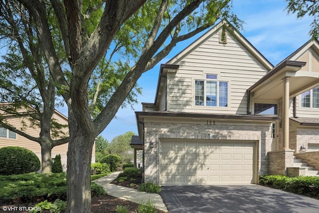 122 Santa Fe Ln, Willow Springs, IL 60480 - view of side of home featuring an attached garage, driveway, and brick siding