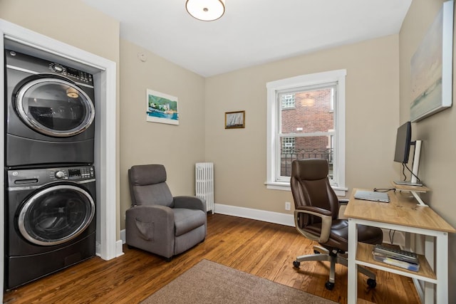 132 Clyde Ave Unit 1, Evanston, IL 60202 - laundry room featuring stacked washer / dryer, radiator heating unit, wood finished floors, and an office area