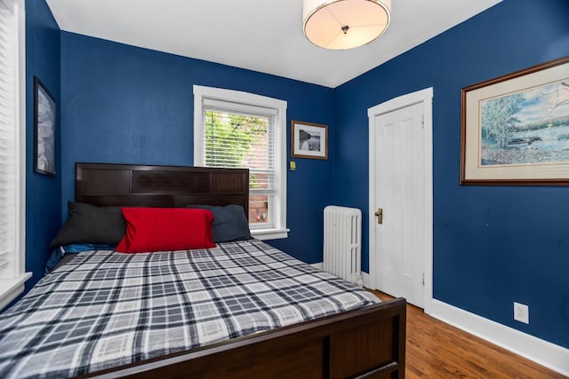 132 Clyde Ave Unit 1, Evanston, IL 60202 - bedroom featuring radiator heating unit and wood finished floors
