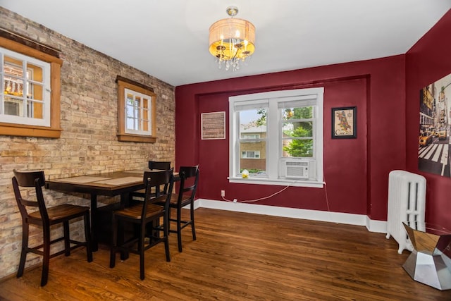 132 Clyde Ave Unit 1, Evanston, IL 60202 - dining area featuring radiator, wood finished floors, cooling unit, and a chandelier