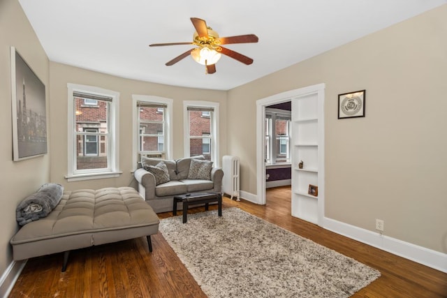 132 Clyde Ave Unit 1, Evanston, IL 60202 - living room with radiator, a ceiling fan, and dark wood-style flooring