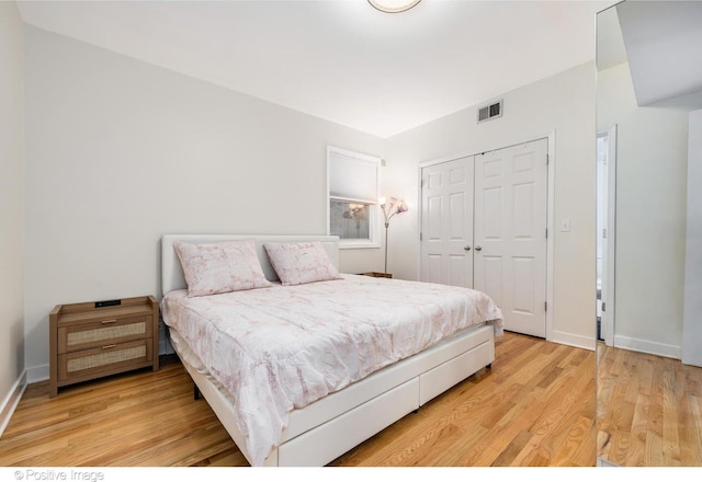 749 S Claremont Ave Unit 2, Chicago, IL 60612 - bedroom with a closet, light wood-style floors, and baseboards