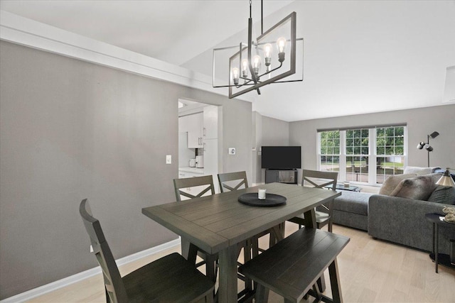 232 Lexington Ct, Grayslake, IL 60030 - dining space with vaulted ceiling, a chandelier, and light wood-style flooring