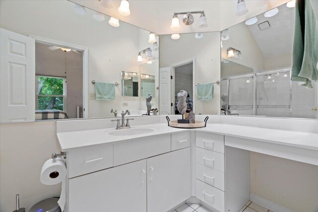 232 Lexington Ct, Grayslake, IL 60030 - full bathroom featuring vanity, a stall shower, tile patterned floors, and vaulted ceiling