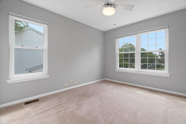 232 Lexington Ct, Grayslake, IL 60030 - carpeted empty room featuring plenty of natural light and ceiling fan