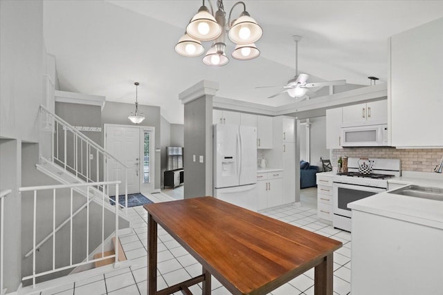 232 Lexington Ct, Grayslake, IL 60030 - kitchen featuring white appliances, vaulted ceiling, light tile patterned floors, tasteful backsplash, and white cabinets