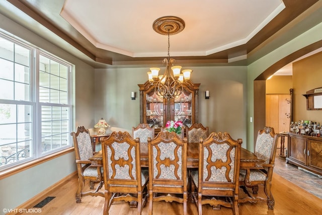 978 Forestview Way, Antioch, IL 60002 - dining space with a chandelier, arched walkways, wood finished floors, and a tray ceiling