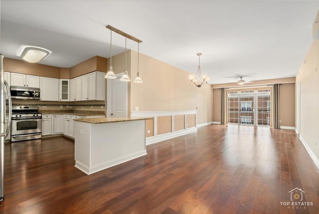 435 W Wood St Unit 410A, Palatine, IL 60067 - kitchen featuring stainless steel appliances, dark wood-style flooring, open floor plan, glass insert cabinets, and a chandelier