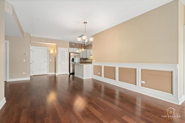 435 W Wood St Unit 410A, Palatine, IL 60067 - unfurnished living room featuring a chandelier, dark wood finished floors, and baseboards