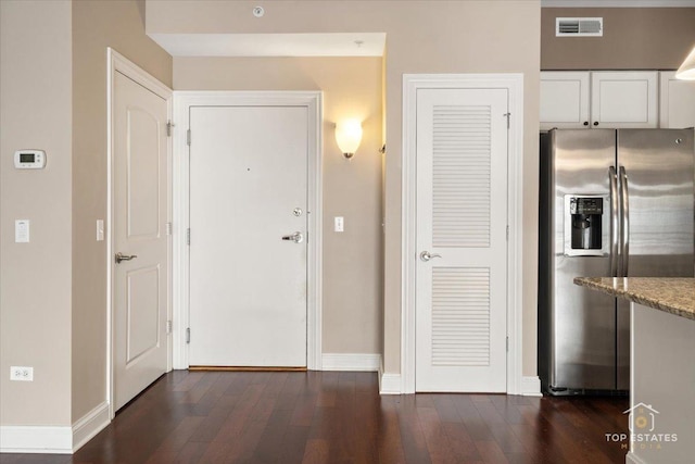 435 W Wood St Unit 410A, Palatine, IL 60067 - kitchen featuring stainless steel refrigerator with ice dispenser, dark wood-style floors, baseboards, and white cabinetry