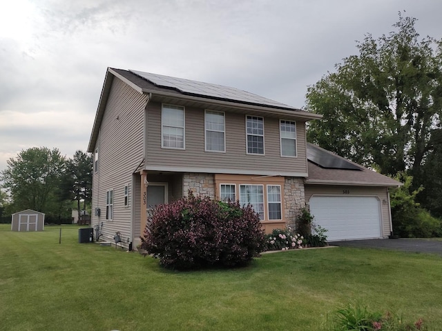 303 Lamplighter Loop, Poplar Grove, IL 61065 - view of front of property with solar panels, an attached garage, cooling unit, a front lawn, and asphalt driveway