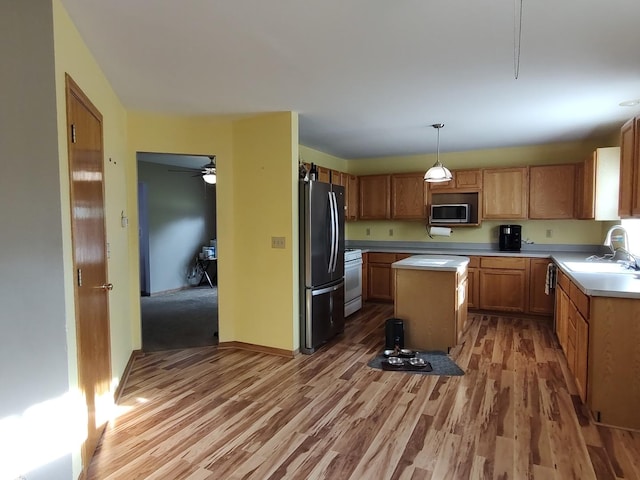 303 Lamplighter Loop, Poplar Grove, IL 61065 - kitchen featuring stainless steel microwave, freestanding refrigerator, a sink, light wood-style flooring, and light countertops