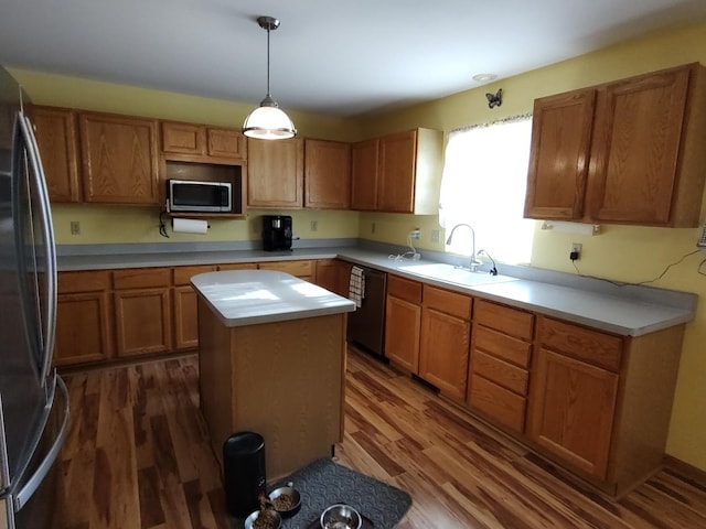 303 Lamplighter Loop, Poplar Grove, IL 61065 - kitchen featuring appliances with stainless steel finishes, a sink, dark wood-style flooring, light countertops, and a center island