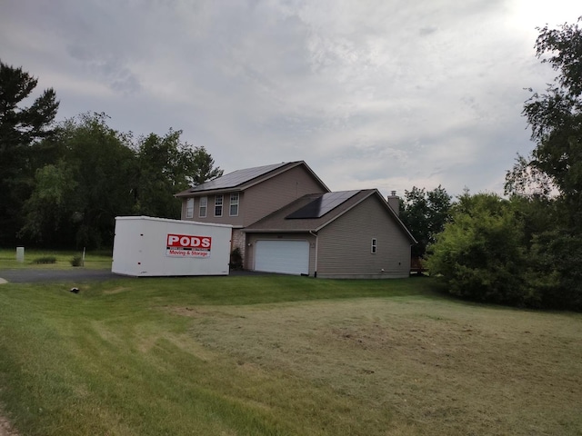 303 Lamplighter Loop, Poplar Grove, IL 61065 - view of property exterior featuring roof mounted solar panels, a lawn, a chimney, and driveway