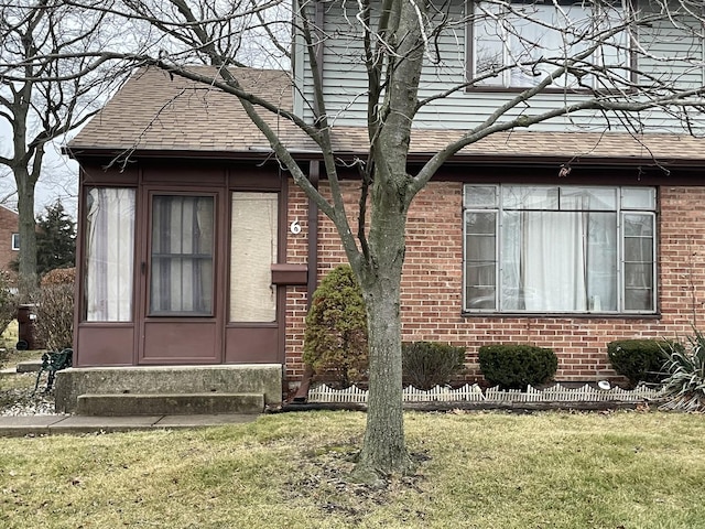 6 Cromwell Rd, Park Forest, IL 60466 - view of property exterior featuring entry steps, a lawn, a shingled roof, and brick siding