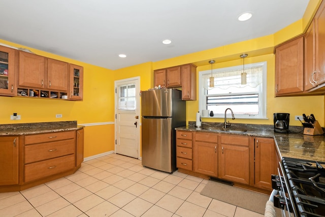 11530 S Campbell Ave, Chicago, IL 60655 - kitchen with freestanding refrigerator, gas stove, brown cabinetry, glass insert cabinets, and light tile patterned flooring