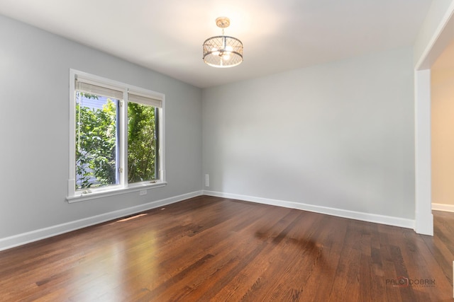 2965 Keystone Rd, Northbrook, IL 60062 - empty room with dark wood-type flooring and a chandelier