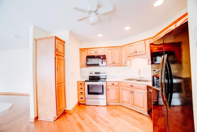 538 E Mulberry St, Watseka, IL 60970 - kitchen with black appliances, a sink, a ceiling fan, light brown cabinetry, and light countertops