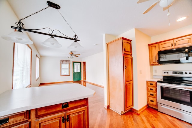 538 E Mulberry St, Watseka, IL 60970 - kitchen with electric stove, black microwave, ceiling fan, and light countertops