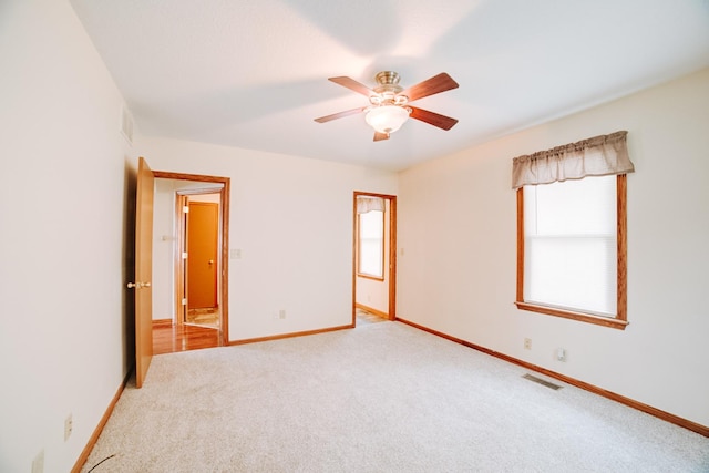 538 E Mulberry St, Watseka, IL 60970 - unfurnished bedroom with light colored carpet, multiple windows, and baseboards