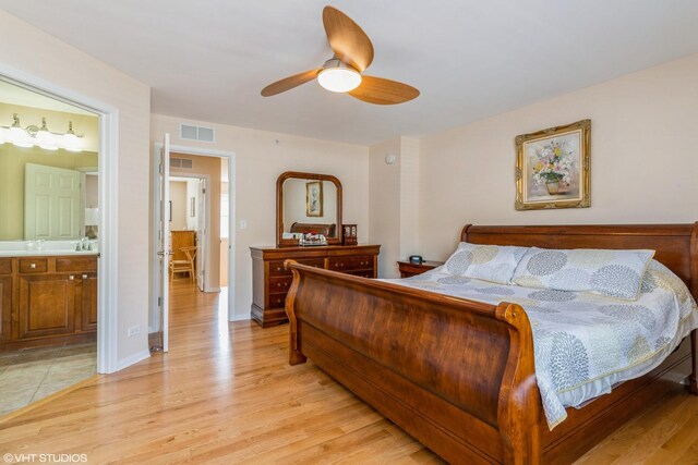 6812 Meadow Ln, Morton Grove, IL 60053 - bedroom with light wood finished floors, connected bathroom, and a ceiling fan