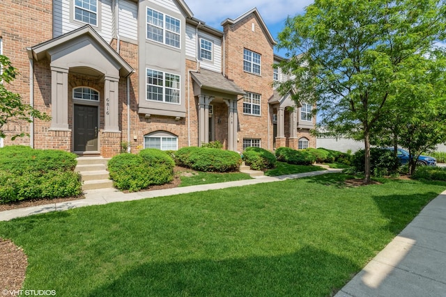 6812 Meadow Ln, Morton Grove, IL 60053 - townhome / multi-family property with a front lawn and brick siding
