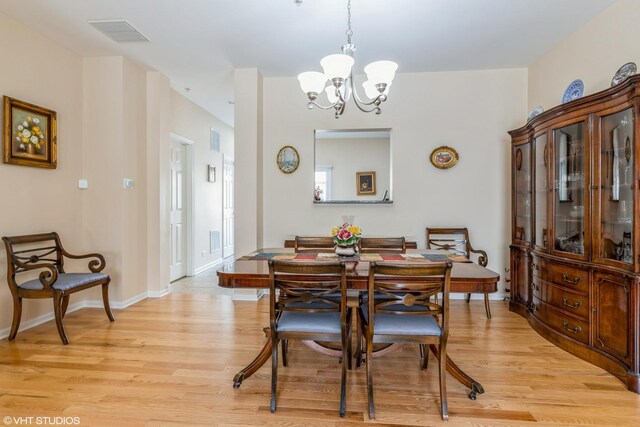 6812 Meadow Ln, Morton Grove, IL 60053 - dining room featuring light wood-style flooring and a chandelier