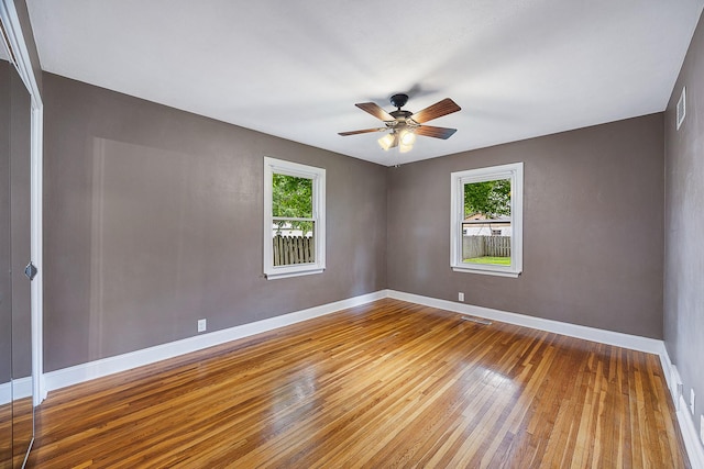 1005 N Walnut St, Normal, IL 61761 - empty room with plenty of natural light, wood-type flooring, and a ceiling fan