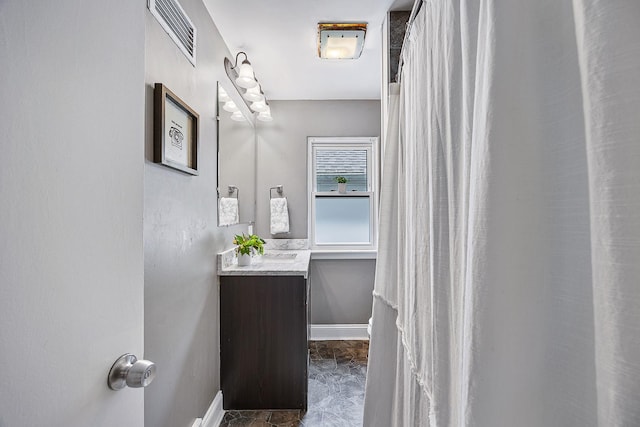 1005 N Walnut St, Normal, IL 61761 - bathroom featuring vanity and baseboards