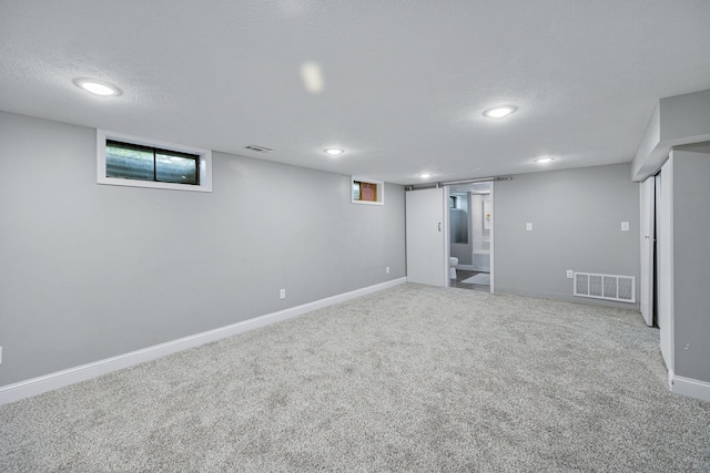 1005 N Walnut St, Normal, IL 61761 - below grade area featuring carpet, a textured ceiling, and recessed lighting