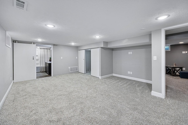 1005 N Walnut St, Normal, IL 61761 - finished below grade area with carpet flooring, recessed lighting, and a textured ceiling