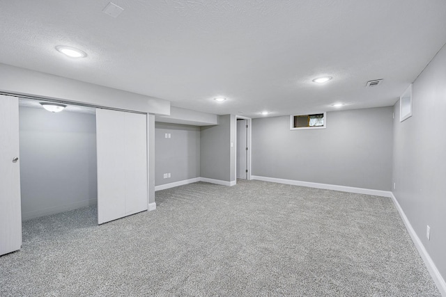 1005 N Walnut St, Normal, IL 61761 - finished below grade area featuring carpet floors, recessed lighting, and a textured ceiling
