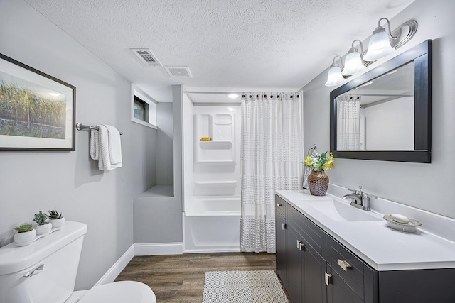 1005 N Walnut St, Normal, IL 61761 - full bathroom with wood finished floors, vanity, a textured ceiling, and shower / bath combination with curtain