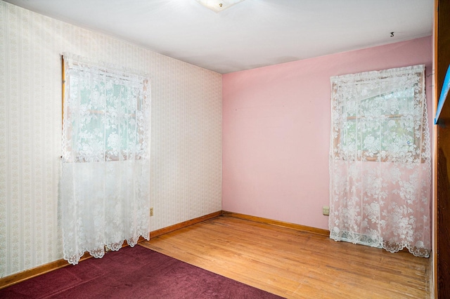 6291 Fallen Timbers Ave, Portage, IN 46368 - unfurnished room featuring wood finished floors, baseboards, and wallpapered walls
