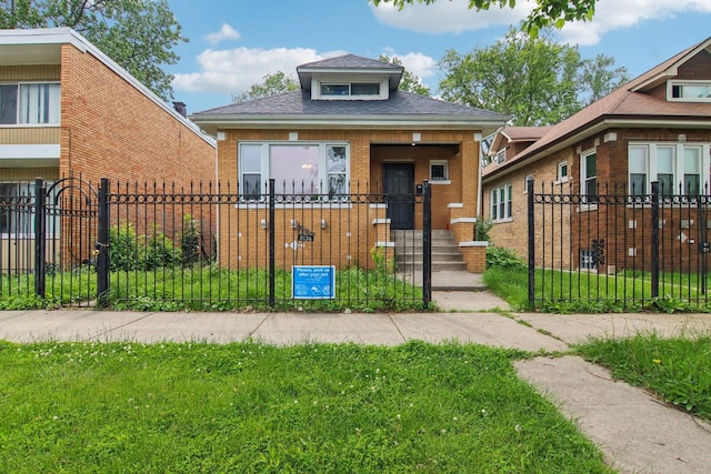 8136 S Manistee Ave, Chicago, IL 60617 - view of front of house featuring brick siding, a shingled roof, a fenced front yard, and a gate