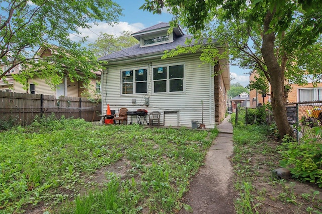 8136 S Manistee Ave, Chicago, IL 60617 - rear view of property featuring roof with shingles