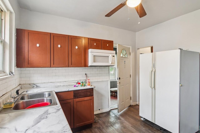 8136 S Manistee Ave, Chicago, IL 60617 - kitchen featuring white appliances, decorative backsplash, dark wood-type flooring, ceiling fan, and brown cabinetry