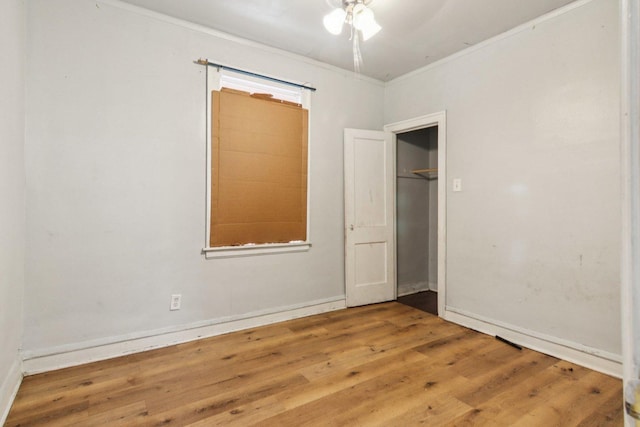 8136 S Manistee Ave, Chicago, IL 60617 - unfurnished bedroom with wood finished floors, crown molding, a closet, and a ceiling fan