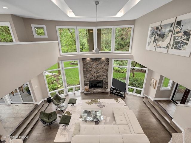 28W535 Purnell Rd, West Chicago, IL 60185 - living area featuring a fireplace, a raised ceiling, a towering ceiling, and wood finished floors