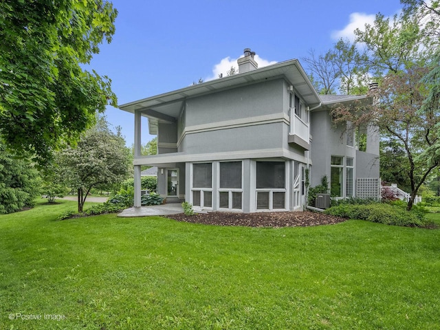 28W535 Purnell Rd, West Chicago, IL 60185 - back of house with a chimney, stucco siding, and a yard