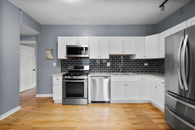 5000 N Glenwood Ave Unit 2, Chicago, IL 60640 - kitchen featuring stainless steel appliances, light countertops, backsplash, and white cabinets